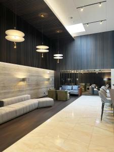 a lobby with couches and tables in a building at Oca Bom Sucesso Hotel in Porto