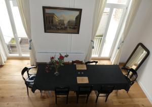 a black table and chairs in a room with windows at Antwerpen perfect location in Antwerp