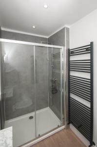 a shower in a bathroom with a glass shower stall at Cara Lodge, Comfortable Self Check-in En-suite Guest Rooms in Berwick-Upon-Tweed
