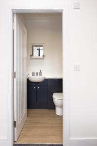a bathroom with a white toilet and a sink at Cara Lodge, Comfortable Self Check-in En-suite Guest Rooms in Berwick-Upon-Tweed