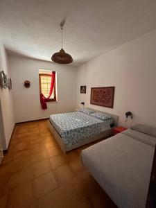 a bedroom with two beds and a window at Lido Apartments in Sciacca