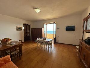 a living room with a table and a view of the ocean at Lido Apartments in Sciacca
