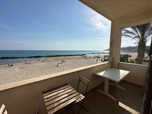 a balcony with a bench and a view of the beach at Lido Apartments in Sciacca