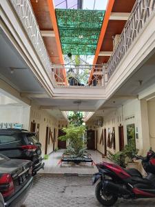 a parking lot with cars parked in a building at Solo Nadamax City Guest House Syariah in Bonorejo