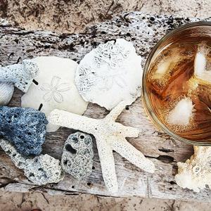a glass of tea and some rocks and a starfish at Mahali Maalum Barefoot Lodge in Mkwaja