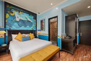 a bedroom with a large bed and a painting on the wall at Eliana Signature Hanoi Hotel in Hanoi