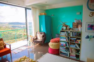 uma sala de estar com uma estante cheia de livros em Paradise Gardens em Xaghra