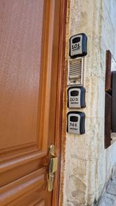 a door with four signs on the side of it at Appartement Hypercentre in Valenciennes
