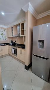 a kitchen with a white refrigerator in a room at Accommodation Front - Dazzling 4 Sleeper near Ushaka Marine World in Durban