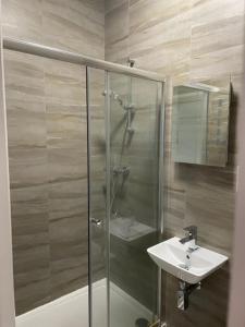 a bathroom with a shower and a sink at Two Bedroom Duplex Apartment The Priory in St. Ives