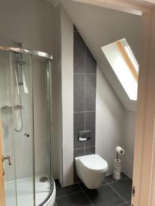 a bathroom with a glass shower and a toilet at Two Bedroom Duplex Apartment The Priory in St. Ives