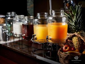 a group of mason jars filled with juice and fruit at Daiwa Roynet Hotel Osaka-Kitahama in Osaka