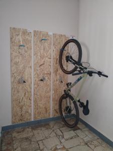 a bike is hanging on a wall next to a room at Turistická ubytovňa Hornád in Spišské Tomášovce