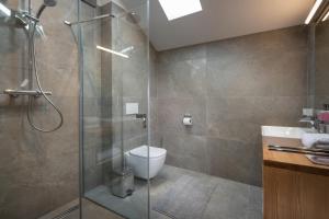 a bathroom with a shower and a toilet and a sink at Mountica Veľká Lomnica in Veľká Lomnica +18 photos
