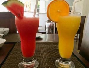 two drinks sitting on a table withspectrative at AMRON RESORT SIGIRIYA in Sigiriya