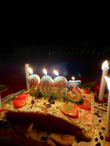 un pastel de cumpleaños con velas encima en Bidiya Desert Camp, en Aflāj