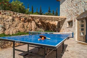 a ping pong table in front of a building at Extravagant Zante Villa Villa Harmonia Great Sea Views 4 Bedrooms Agios Nikolaos in Koríthion