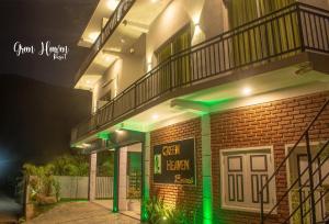 un bâtiment en briques avec des lumières vertes devant lui dans l'établissement Green Heaven Resort Kandy, à Kandy
