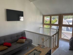 a living room with a couch and a table at maison de village in Ax-les-Thermes