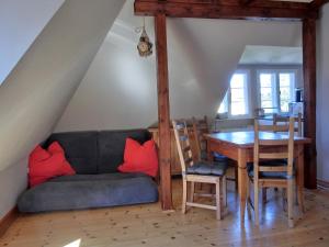 a dining room with a couch and a table at Strandstraße 60 Ferienwohnung S16 in Graal-Müritz