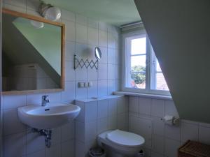 a bathroom with a sink and a toilet and a window at Strandstraße 60 Ferienwohnung S16 in Graal-Müritz