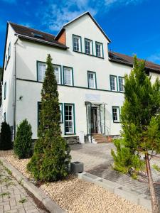 a white house with trees in front of it at Ferienhaus Doina in Gehlberg +64 photos
