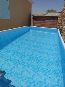 a large blue swimming pool in a house at MiniCasa con vistas a las Hoces del río Riaza. in Montejo de la Vega de la Serrezuela