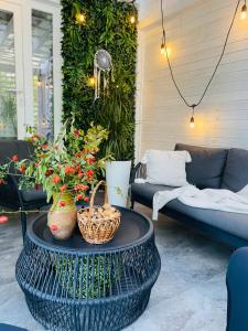 a patio with a table with flowers and a couch at Aici te simți ca acasa 2 in Iaşi