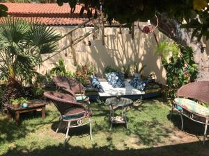 a garden with chairs and a table with at Casa Éolica in Barra Grande
