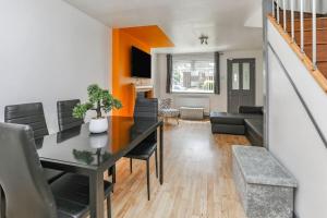 a living room with a dining room table and a couch at Peaceful Urban Getaway in Liverpool