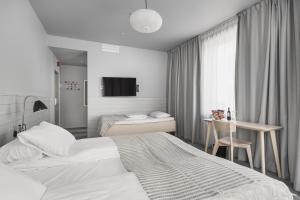 Postel nebo postele na pokoji v ubytování Heimen Hotel