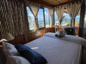 a bedroom with two beds with a view of the ocean at Eco Lagoon in Phu Quoc