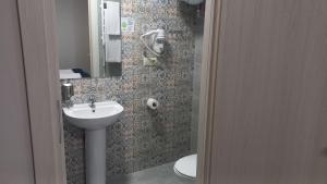a bathroom with a sink and a toilet at Optima Collection Nizhyn in Nizhyn