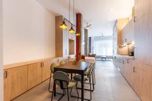 a kitchen and dining room with a table and chairs at VR Palace Apartments in Madrid