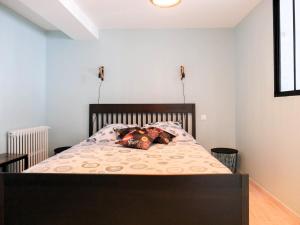 a bedroom with a bed with two pillows on it at Les Clématites de Saint-Aignan 4p, 7 min du Zoo in Saint-Aignan