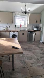 a kitchen with a wooden table and a counter top at ACCOMADATION WREXHAM in Wrexham