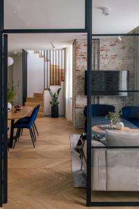 a living room and dining room with a dining table at Tyzenhauz Apartments Superior in Krakow