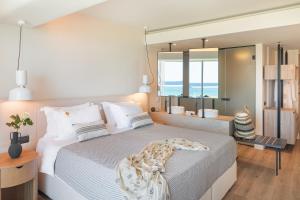 a bedroom with a large bed and a large mirror at Erato by Samian Mare in Karlovasi