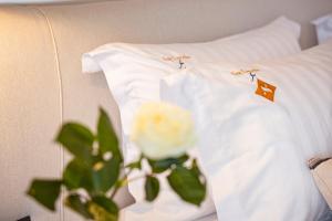 a pair of white t shirts sitting on a bed at Erato by Samian Mare in Karlovasi