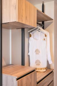 a white shirt is hanging in a closet at Erato by Samian Mare in Karlovasi