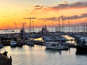 a group of boats docked in a marina at sunset at Hotel Grande Italia in Chioggia