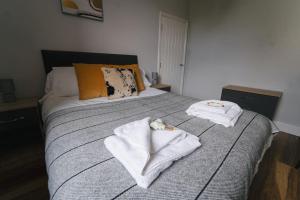 a bedroom with a bed with towels on it at Oldfield Apartments - Bath in Bath