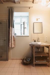 a bathroom with a sink and a window at Flecksches Gut in Leipzig