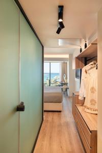 a bedroom with a bed and a view of the ocean at Erato by Samian Mare in Karlovasi