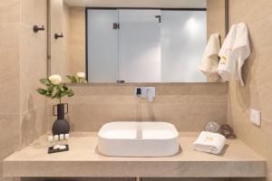 a bathroom with a sink and a mirror at Erato by Samian Mare in Karlovasi