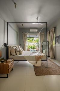 a bedroom with a large bed with a large mirror at LohonoStays Castello Villa 1 in Vagator
