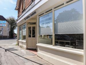 a store front with a sign in the window at The Old Post Office in Canterbury