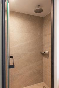 a shower with a glass door in a bathroom at Erato by Samian Mare in Karlovasi