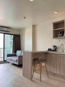 a kitchen and living room with a couch and a table at TheView Chaengwattana14 เดอะวิวแจ้งวัฒนะ14 in Bangkok