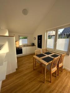 a kitchen and dining room with a table and chairs at Ferienhaus Fam. Mersmann in Papenburg